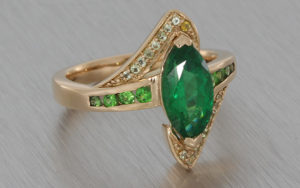 Unusual emerald and rose gold engagement ring