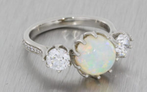 Platinum opal three stone ring with 2 x round brilliant diamonds