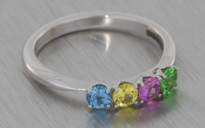 18K ring set with sapphires, topaz and garnet
