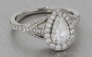 Ornate pear cut diamond halo engagement ring